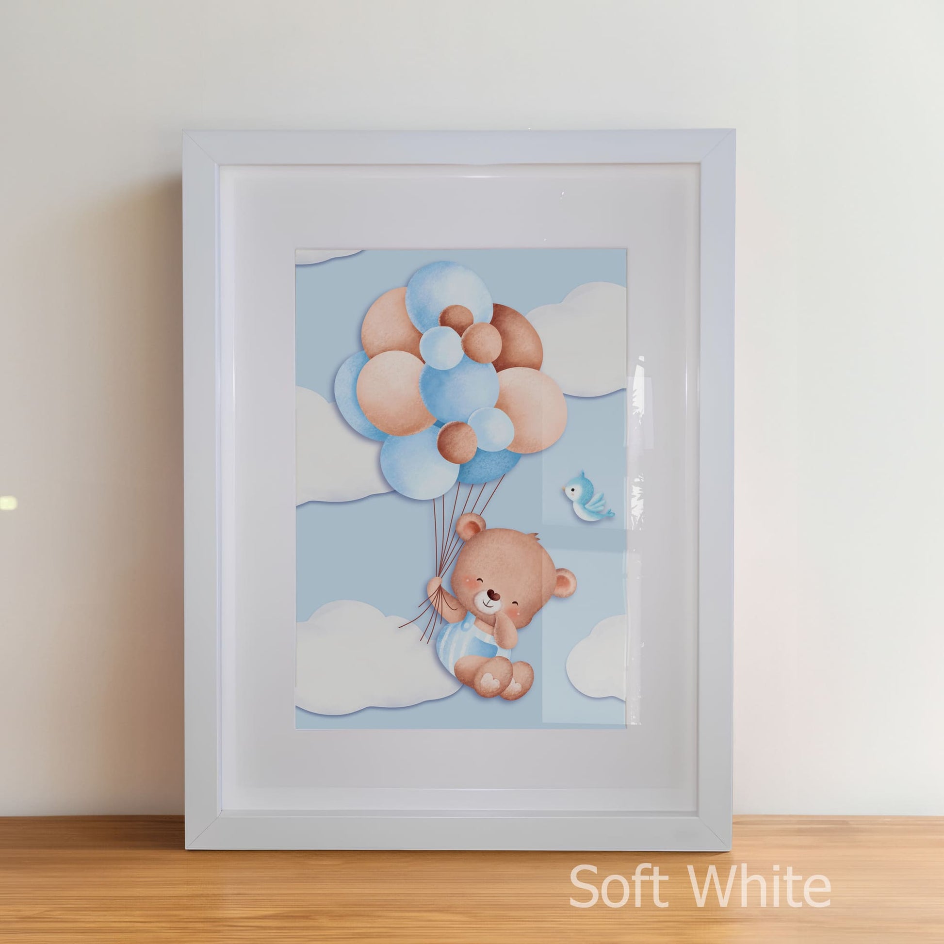 Framed artwork of a teddy bear with balloons on a white wall.