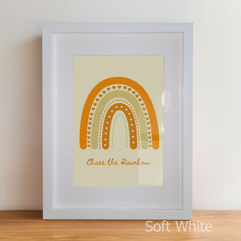Framed artwork with a rainbow design and text on a beige background
