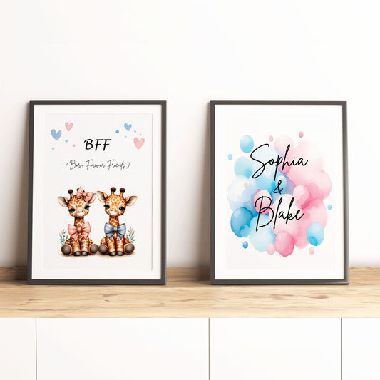 Set of 2 personalised prints for twins' nursery décor. One print features twin giraffes, one wearing a pink bow and the other wearing a blue bow. The prints also include watercolour splashes with children's names in bold black lettering. 