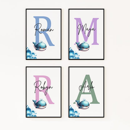 Image featuring four prints, each with a small whale image overlaid on a large initial in the background. The initials in each print are of different colours, with a personalised name written across them.