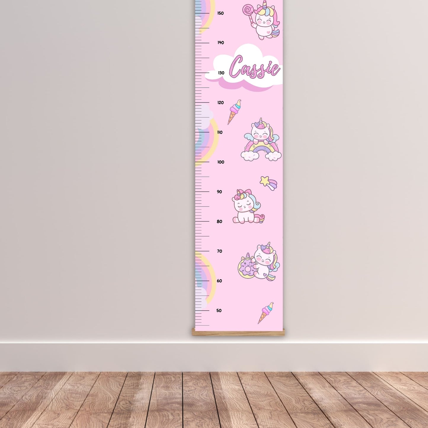 Childs height chart in pastel pink with a cute rainbow, unicorn  and icecream design. Personalised with childs name. Available on a black, white or natural hanger