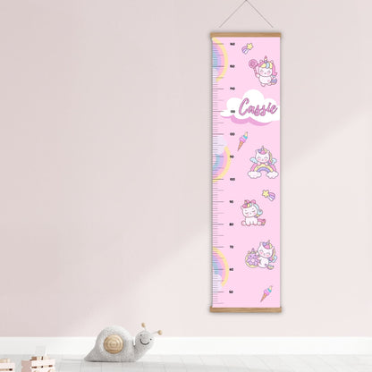 Childs height chart in pastel pink with a cute rainbow, unicorn  and icecream design. Personalised with childs name. Available on a black, white or natural hanger