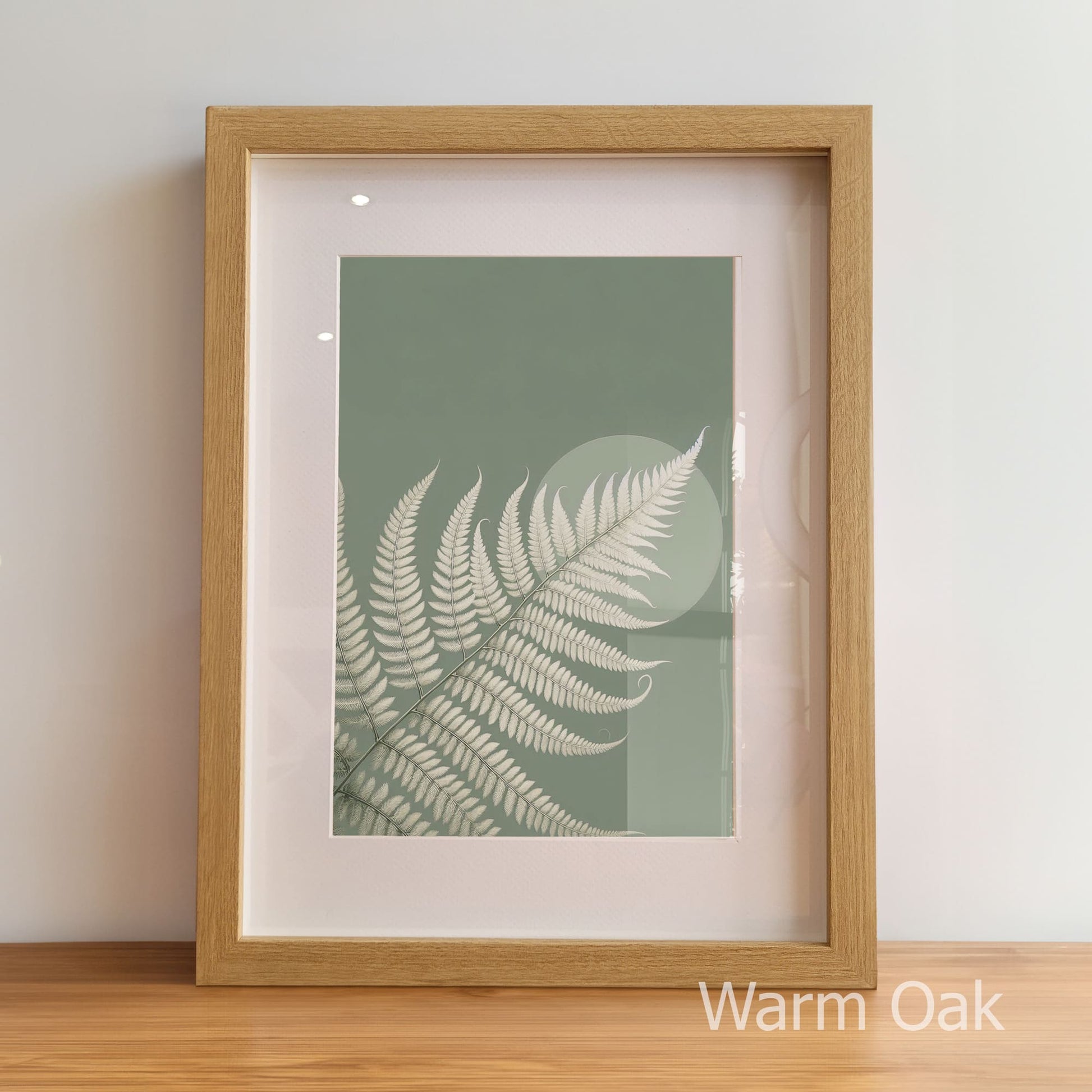 Framed artwork with a fern leaf design on a light background