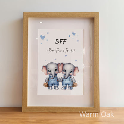 Framed artwork with two elephants holding hands and the text 'BFF (Born Forever Friends)' on a light background.