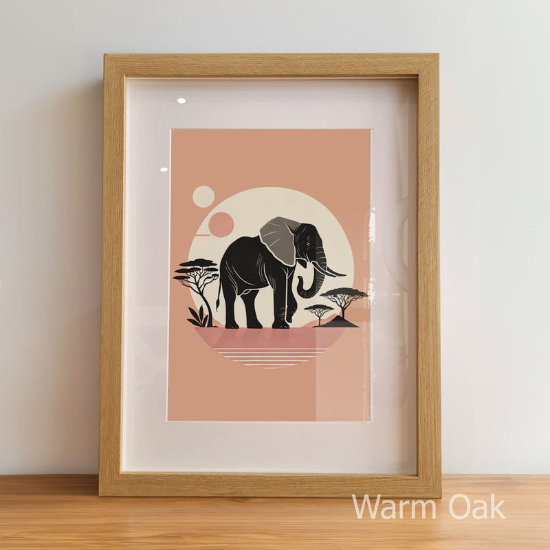Framed artwork with an elephant design on a peach background, displayed on a light wooden floor.