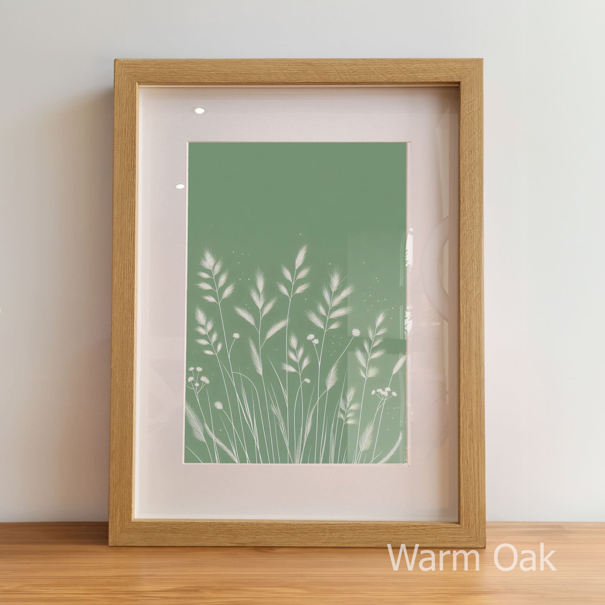Framed artwork with a green plant design on a light background