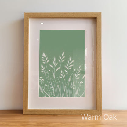 Framed artwork with a green plant design on a light background