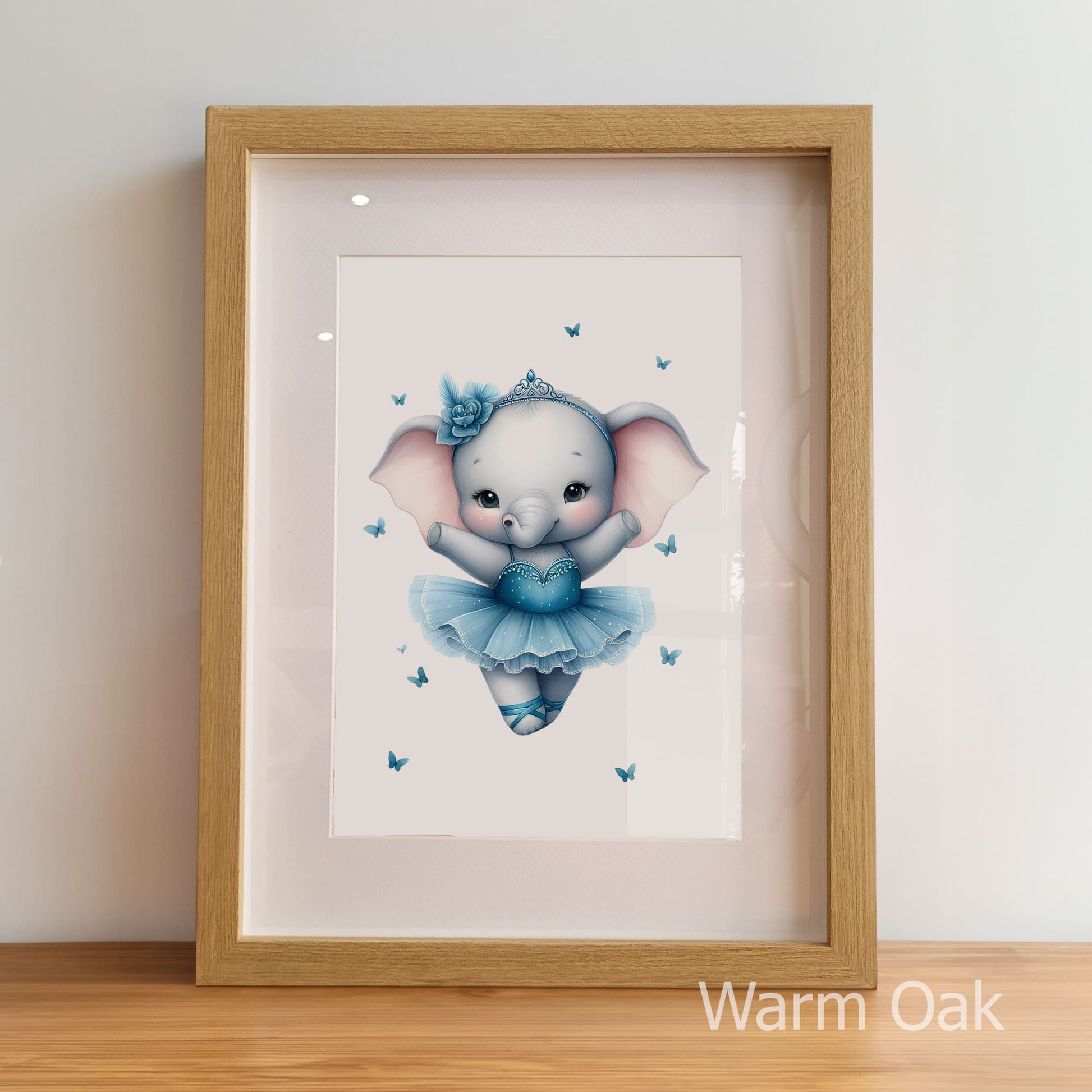 Framed artwork of a cartoon elephant in a blue dress with butterflies on a light background.
