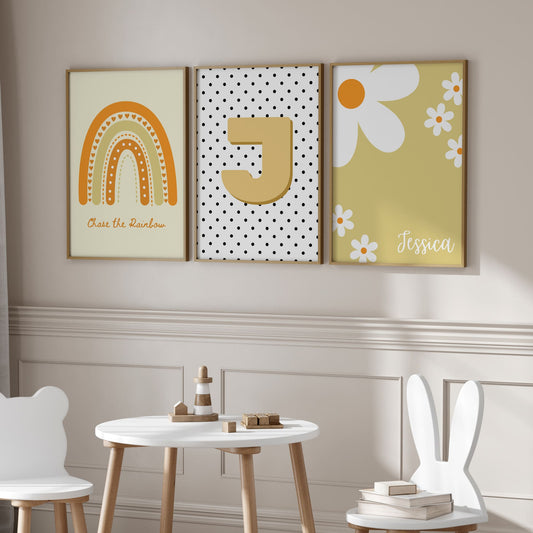 3 boho style nursery prints in shades of yellow. One print with a boho yellow rainbow, one with a spotty black and white background, and childs initial, one with daisys and childs name